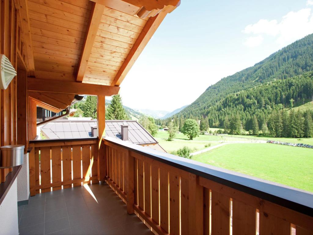 a balcony of a cabin with a view of a green field at Chalet apartment in Saalbach-Hinterglemm in Saalbach-Hinterglemm