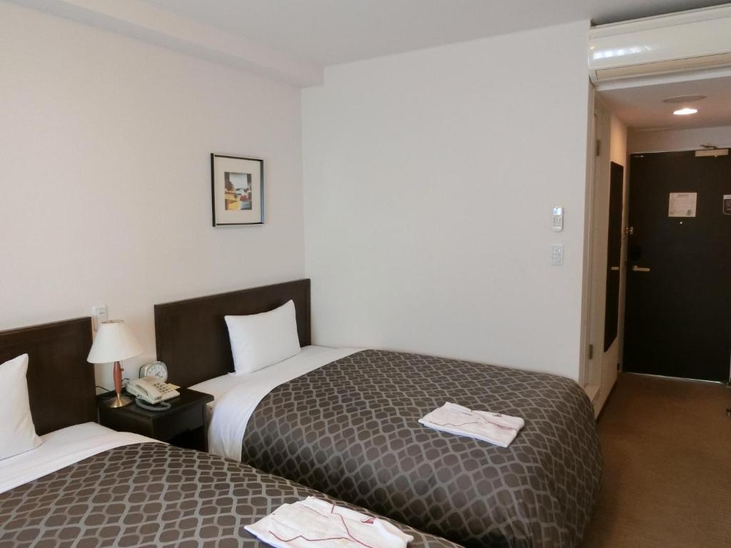 Postel nebo postele na pokoji v ubytování Laxio Inn