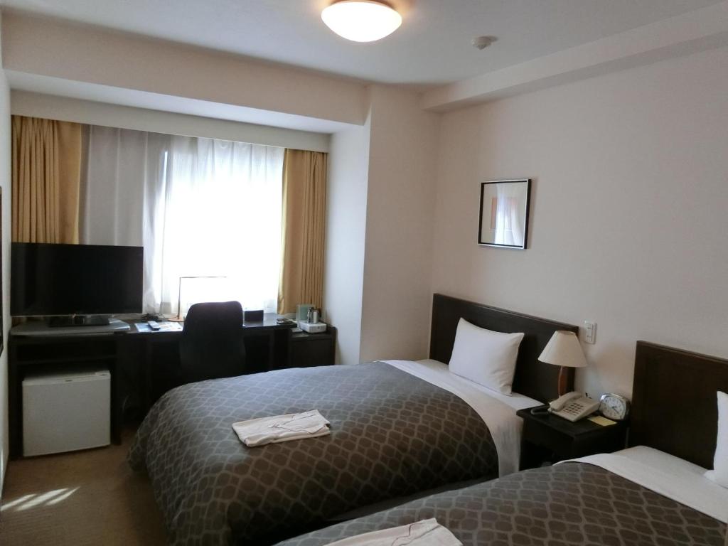 Postel nebo postele na pokoji v ubytování Laxio Inn