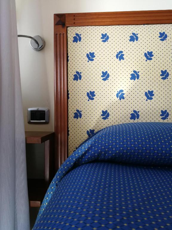Postel nebo postele na pokoji v ubytování Hotel Il Castellaccio