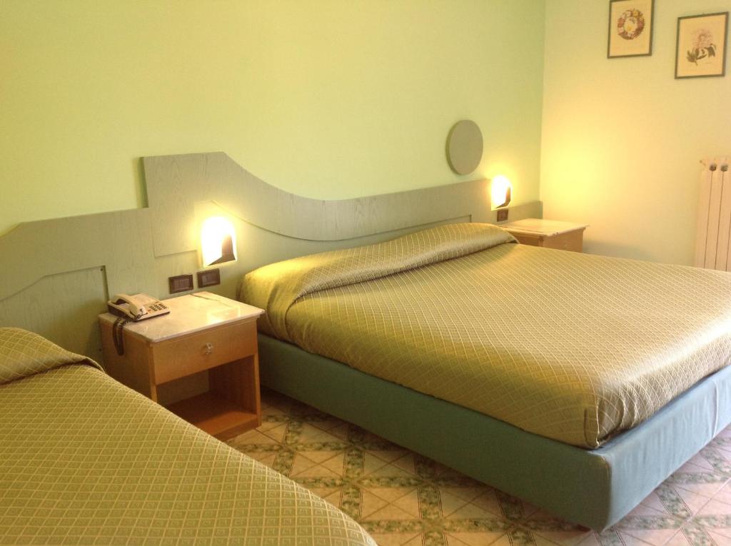 Postel nebo postele na pokoji v ubytování Hotel Giovanna