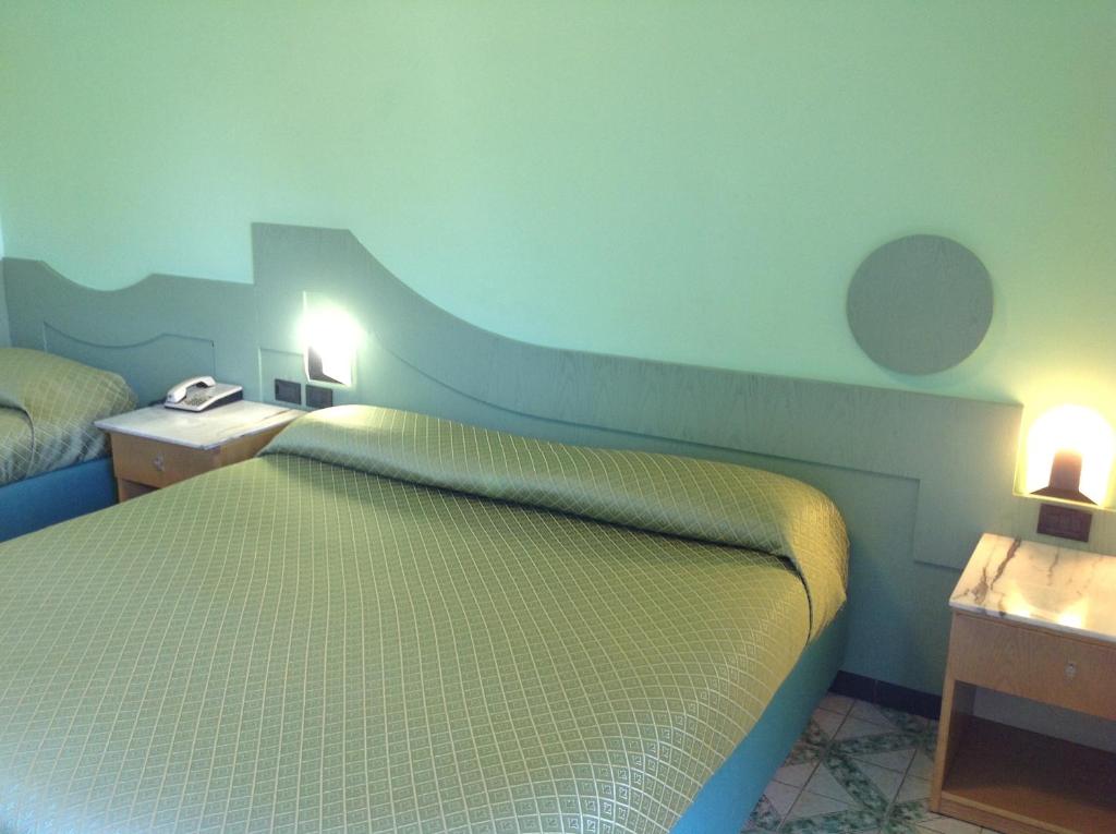 Postel nebo postele na pokoji v ubytování Hotel Giovanna