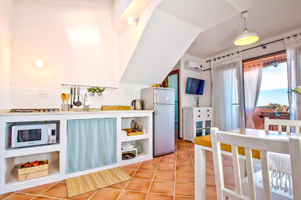 a kitchen with white cabinets and a counter top at Villa Brezza Marina in Nebida