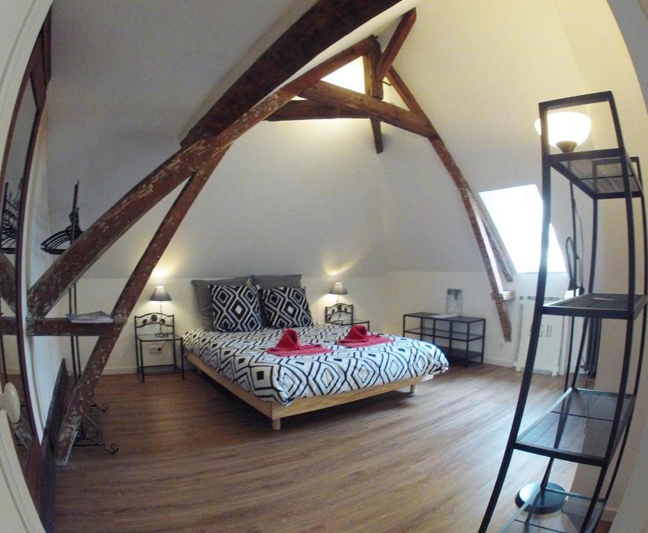 a bedroom with a bed in a attic at Alex Guest House in Dozulé