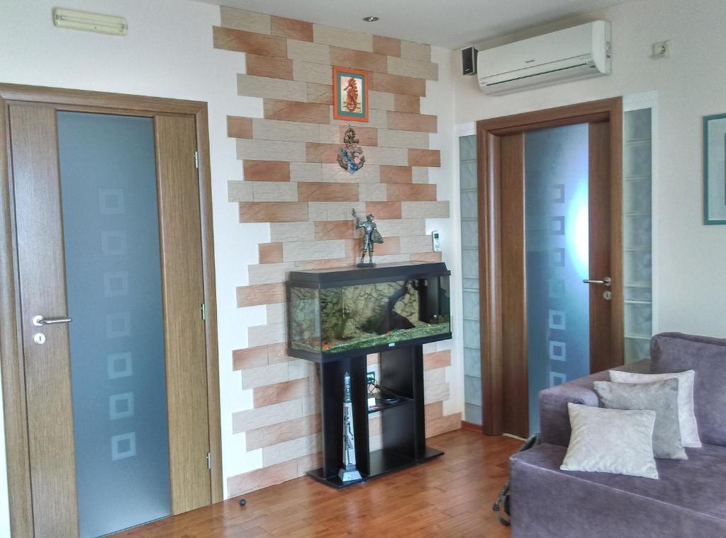 a living room with a fish tank on a wall at Apartments Europa in Starigrad