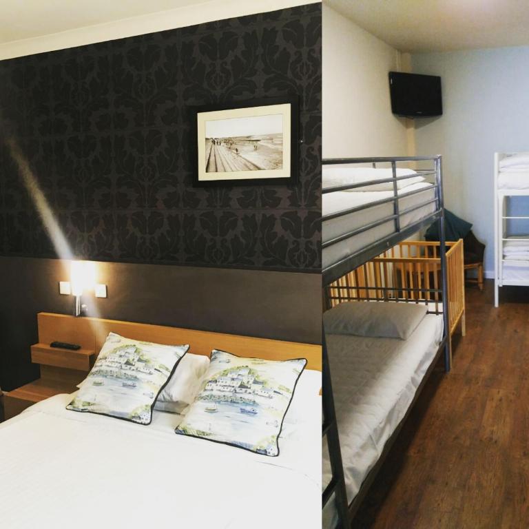 a bedroom with a bunk bed and a bunk room with a staircase at The Anchor Hotel & Bars in Ingoldmells