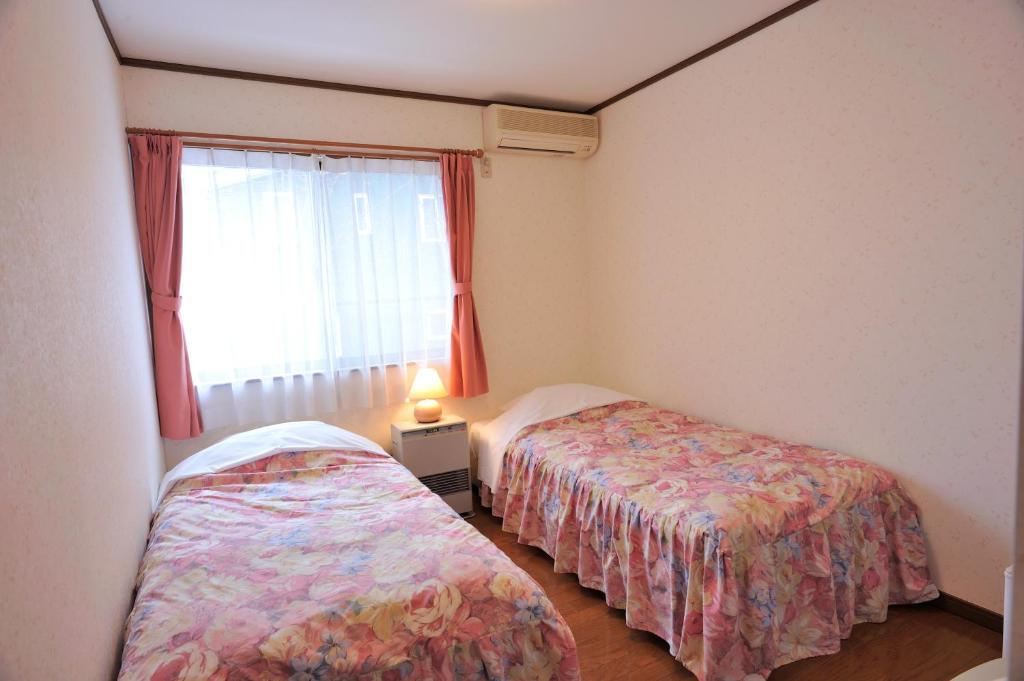 Postel nebo postele na pokoji v ubytování Anise Garden