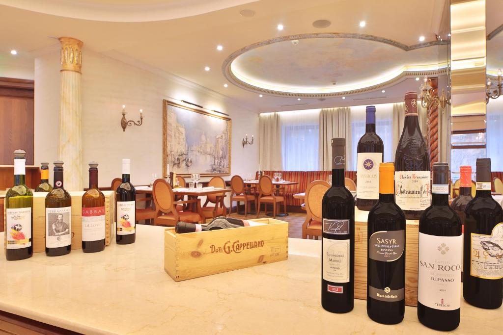 a bunch of bottles of wine sitting on a counter at Retro Riverside Wellness Resort in Karlovy Vary
