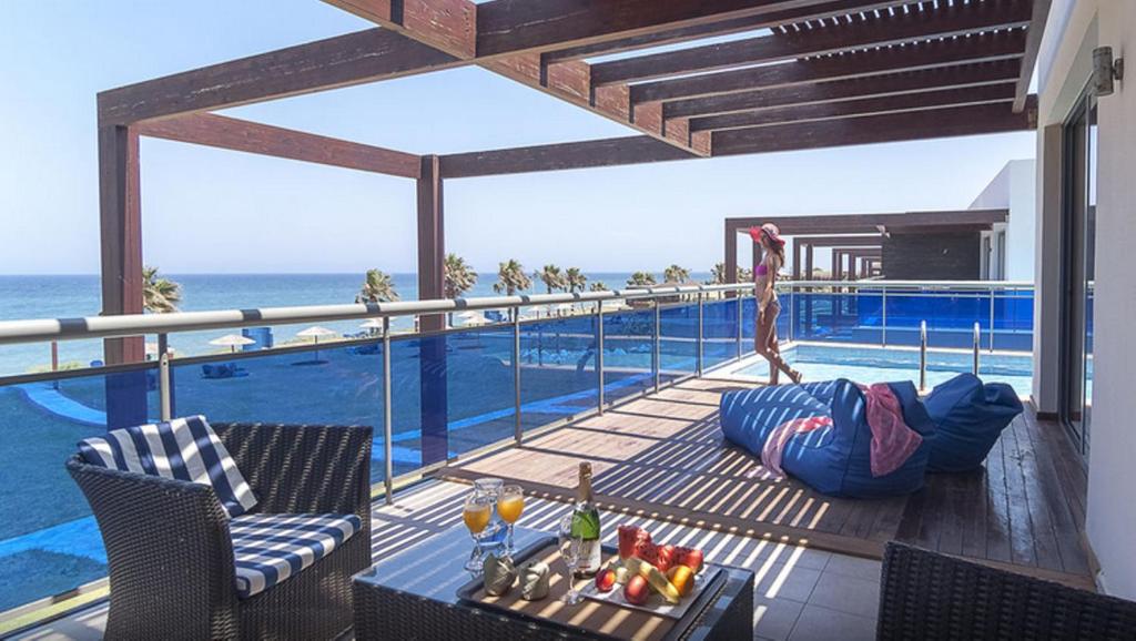 a view of a swimming pool from the balcony of a resort at All Senses Nautica Blue Exclusive Resort & Spa - All Inclusive in Fánai