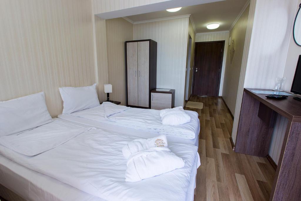 Postel nebo postele na pokoji v ubytování Hotel Nikol