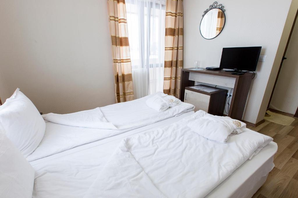 Postel nebo postele na pokoji v ubytování Hotel Nikol
