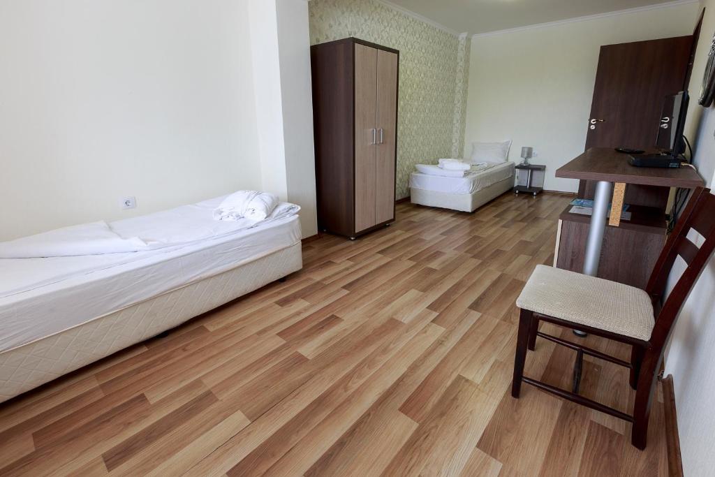 Postel nebo postele na pokoji v ubytování Hotel Nikol