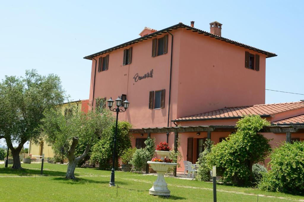 a pink building with a fountain in front of it at Villa Brancatelli in Riotorto