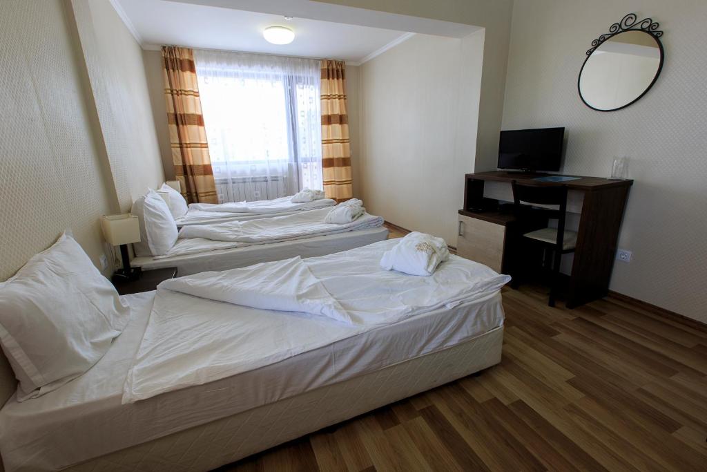 Postel nebo postele na pokoji v ubytování Hotel Nikol