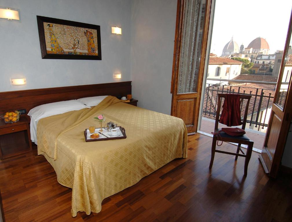 Postel nebo postele na pokoji v ubytování Hotel Palazzo Vecchio