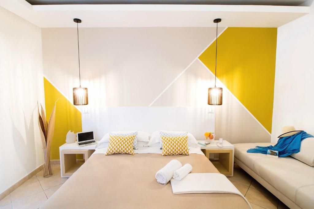 a room with a bed and a couch at Hotel Rivage in Sorrento