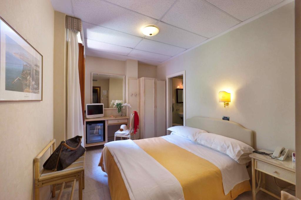 a hotel room with a bed and a television at Hotel Rivage in Sorrento