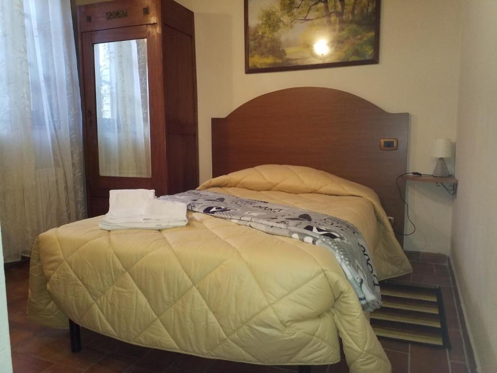 A bed or beds in a room at Il Pozzo Di Sant'Andrea