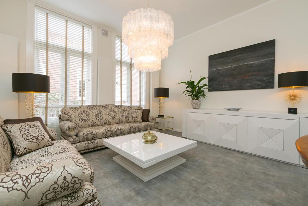 a living room with a couch and a coffee table at The City Palace - R.Q.C. in The Hague