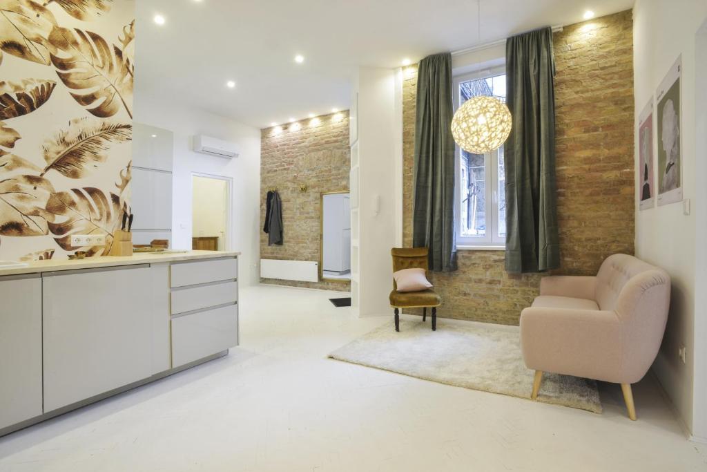 a living room with a couch and a chair at Golden Leaf Apartment in Budapest