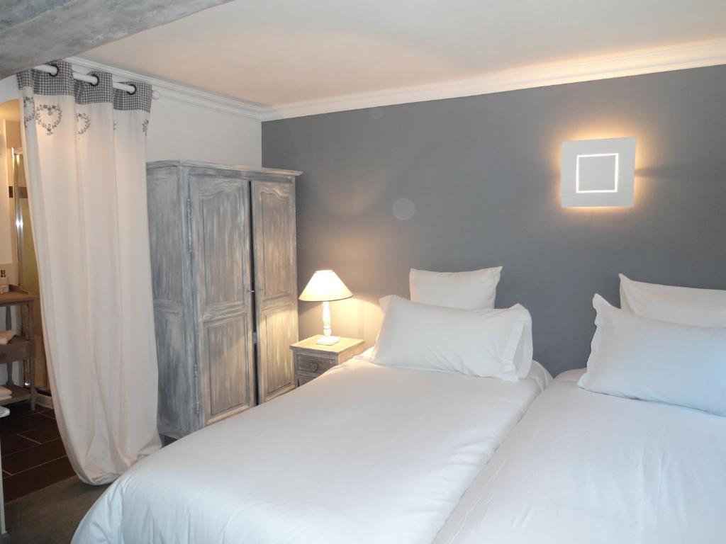 Postel nebo postele na pokoji v ubytování Hotel le P'tit Beaumont