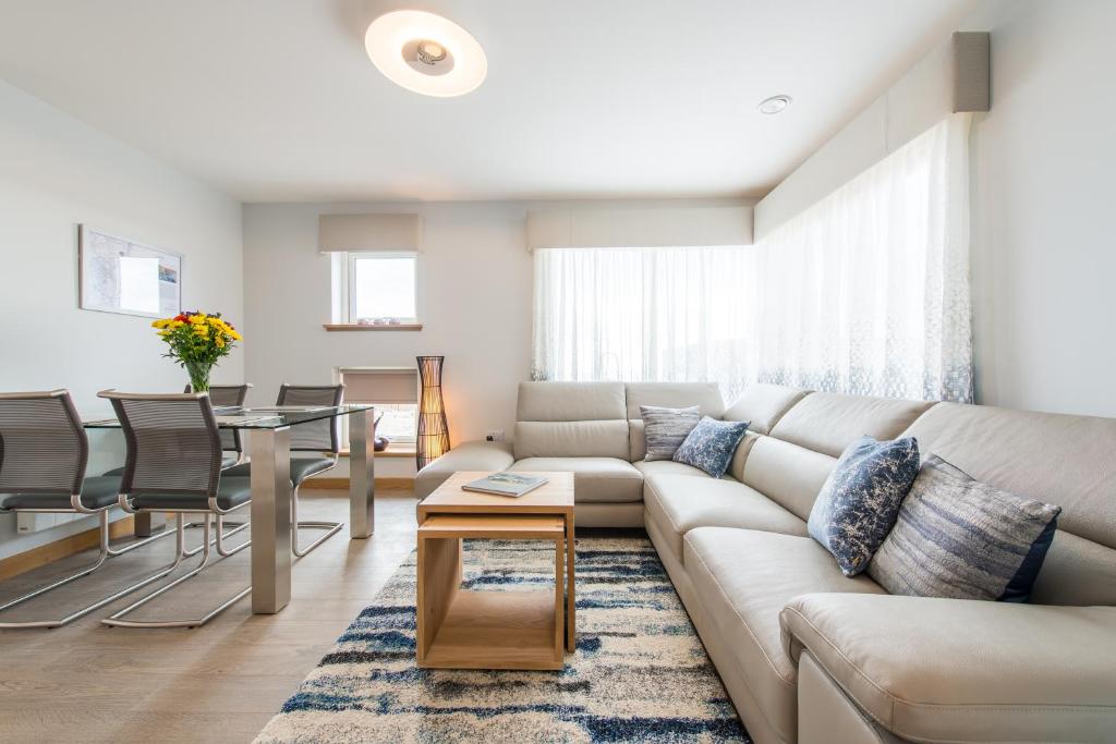 a living room with a couch and a table at Dalriada Lodges Ruthery in Stonehaven