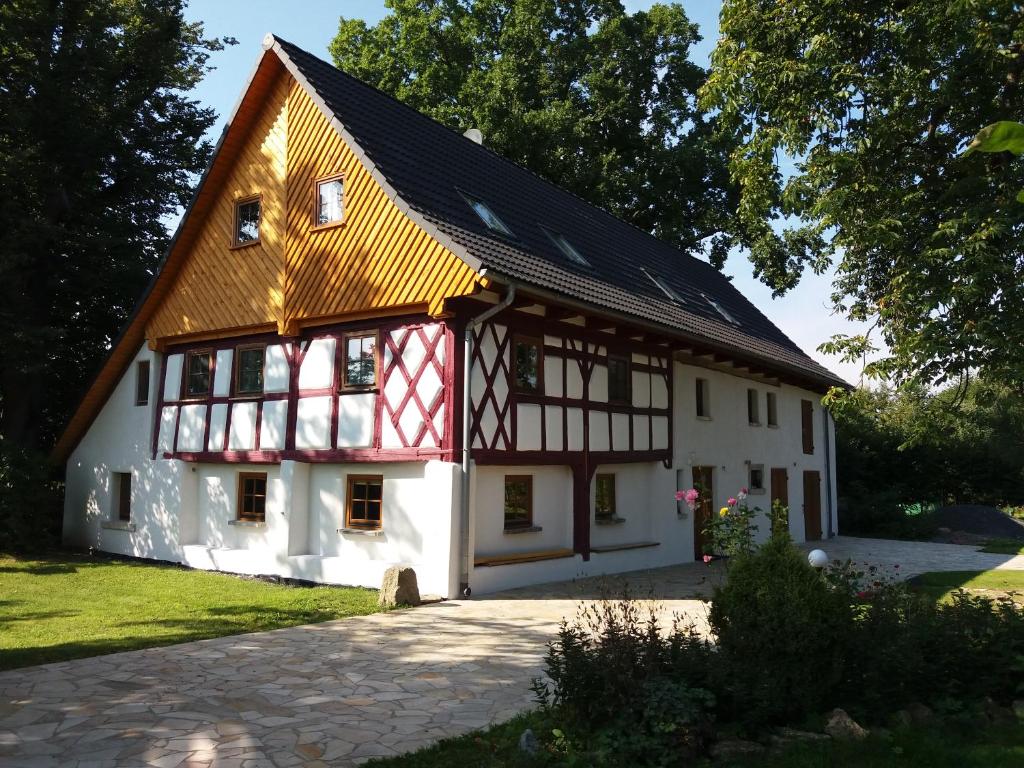 a white and red house with a gambrel roof at Gajowe Zacisze in Mirsk