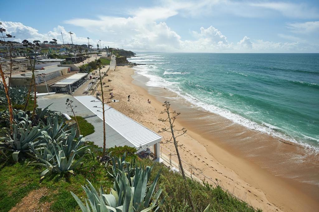 a view of a beach and the ocean at modern flat in Estoril