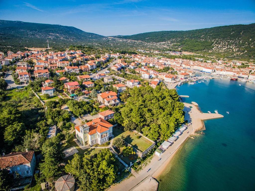 an aerial view of a town next to the water at Apartments Vodaric in Cres