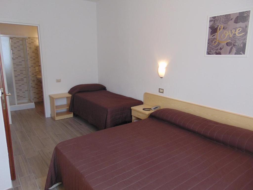 Postel nebo postele na pokoji v ubytování Albergo Rossana
