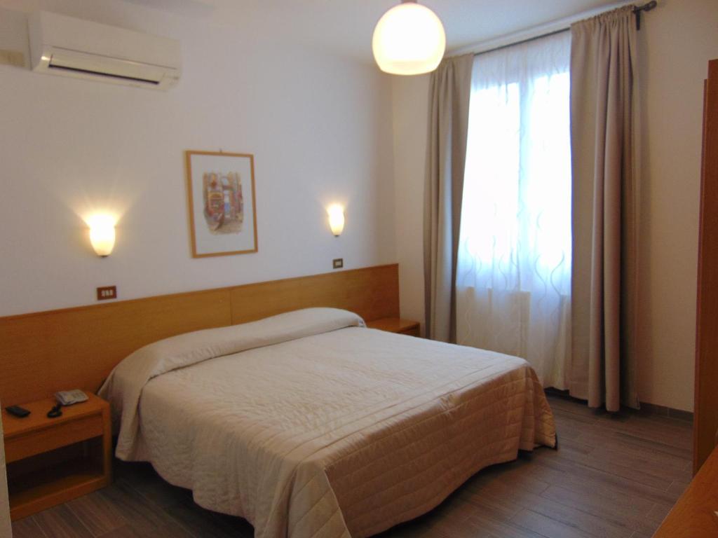 Postel nebo postele na pokoji v ubytování Albergo Rossana