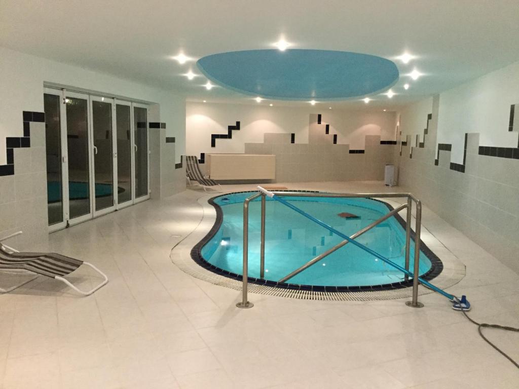 a large swimming pool in a room with a ceiling at Justyna in Pardubice