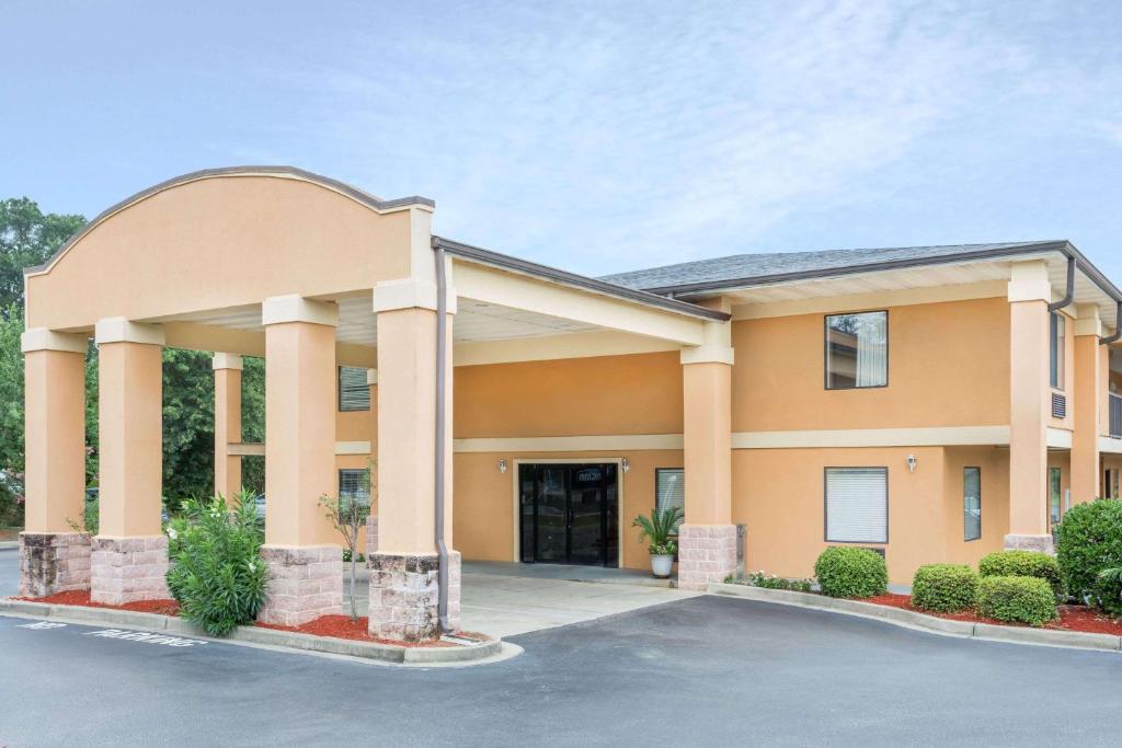 a building with a parking lot in front of it at Days Inn by Wyndham Blythewood North Columbia in Blythewood