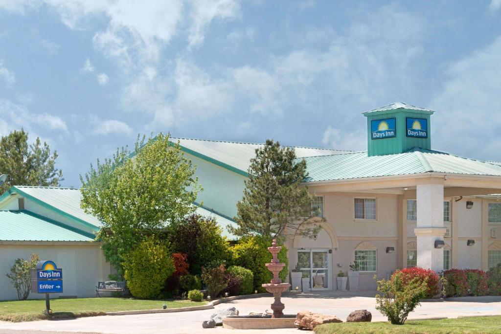 a building with a clock tower on top of it at Days Inn by Wyndham Dalhart in Dalhart