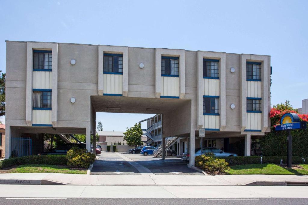 a building with an archway in front of a street at Days Inn by Wyndham Orange Anaheim in Orange