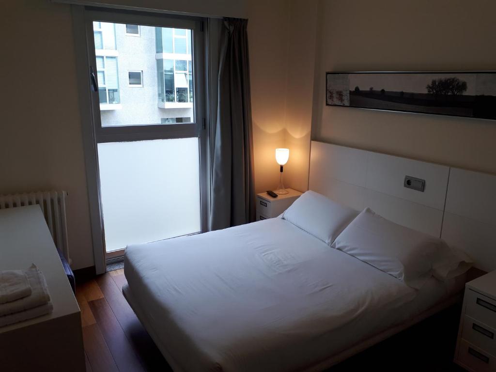 Een bed of bedden in een kamer bij PR Blanco