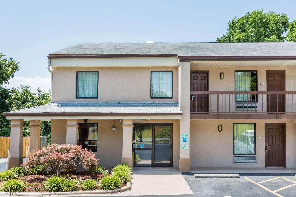 a house with a balcony on the front of it at Days Inn by Wyndham Winston Salem North in Winston-Salem