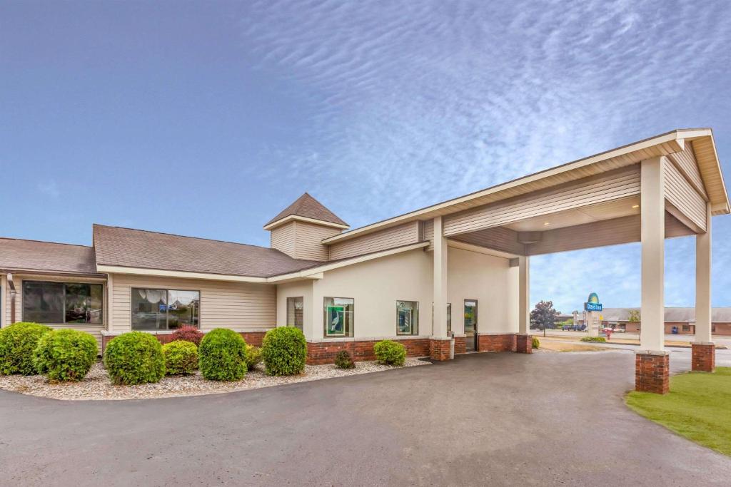 a large house with a garage at Days Inn by Wyndham Alpena in Alpena