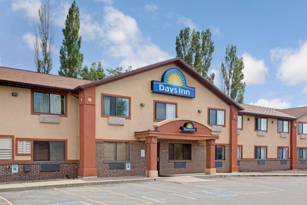 a hotel with a sign on the front of a building at Days Inn by Wyndham Clearfield in Clearfield