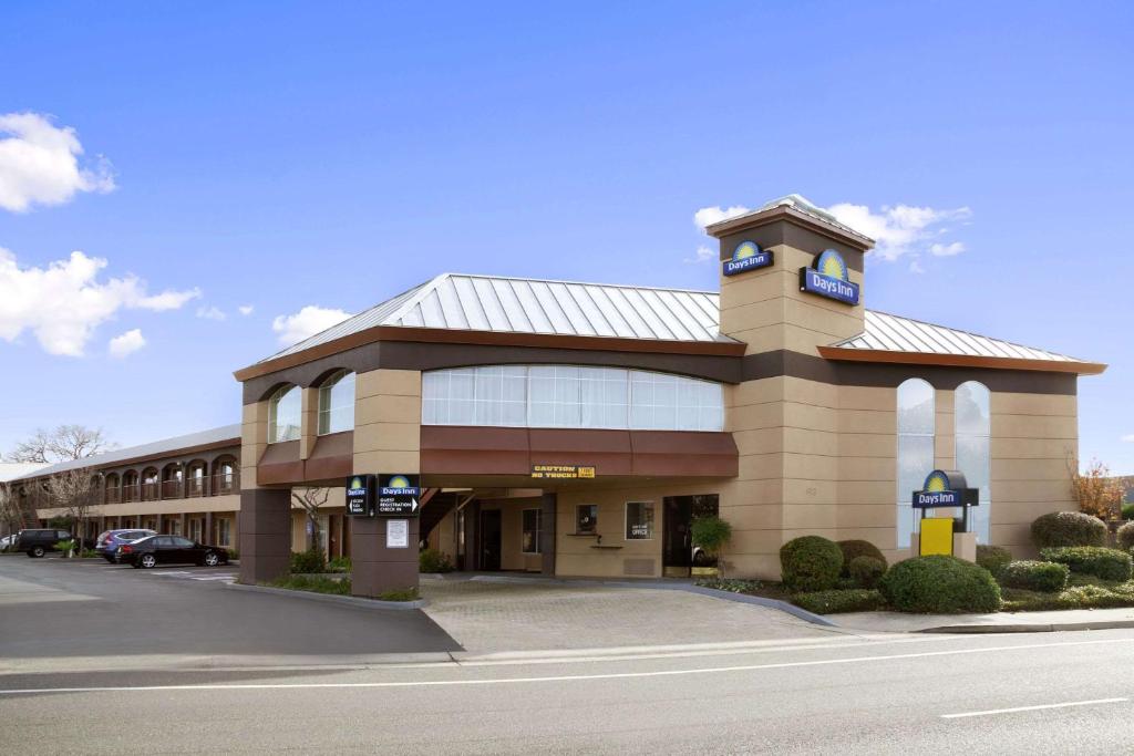 a large building with a clock on top of it at Days Inn by Wyndham Rocklin/Sacramento in Rocklin