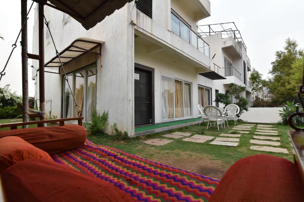 a house with a rug in the yard at Modern Villa One in Lonavala