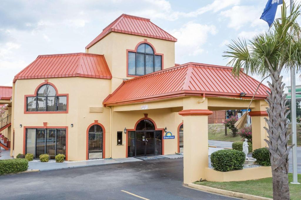 a building with a red roof at Days Inn by Wyndham Orangeburg in Orangeburg