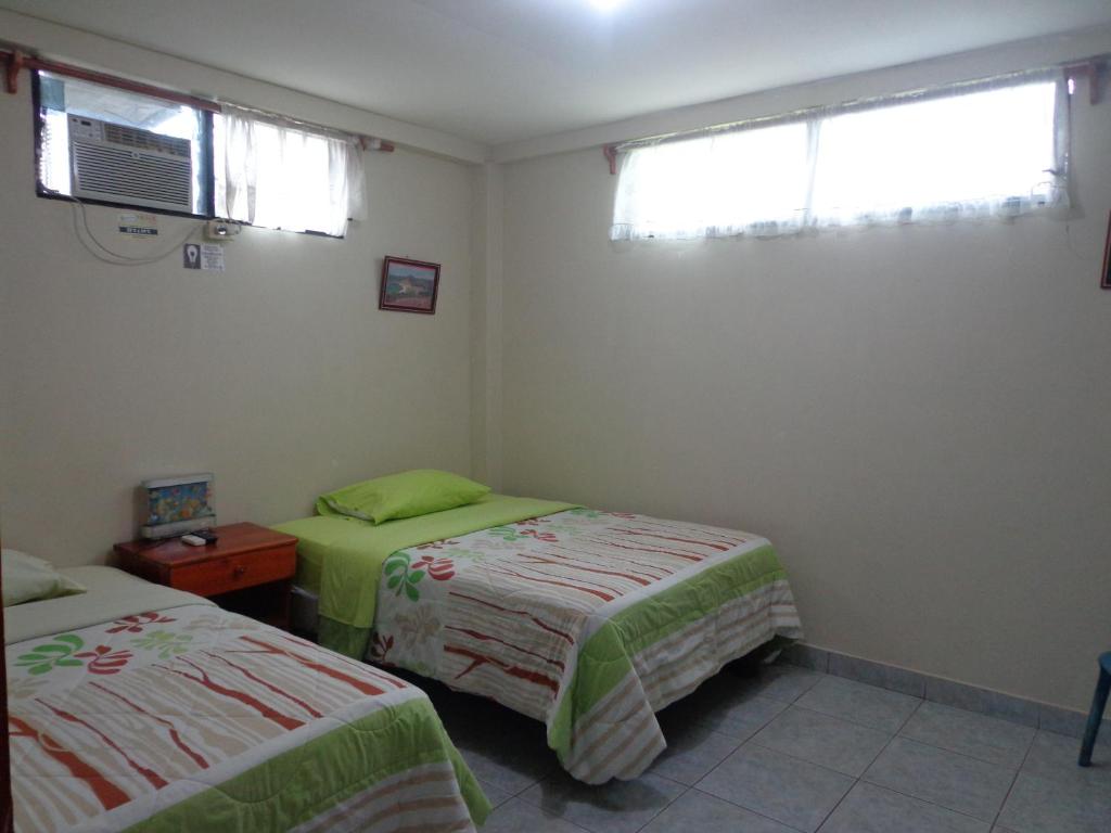 Postel nebo postele na pokoji v ubytování Hostal Nathaly