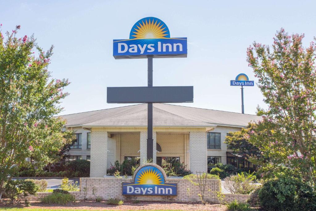 a days inn sign in front of a building at Days Inn by Wyndham Spartanburg Waccamaw in Southern Shops