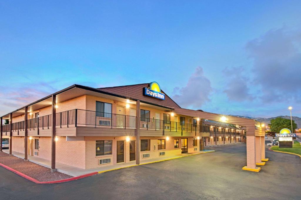 a hotel with a parking lot in front of it at Days Inn by Wyndham East Albuquerque in Albuquerque