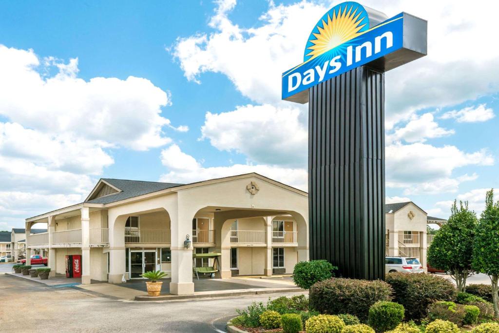 a days inn sign in front of a building at Days Inn by Wyndham Shorter in Shorter