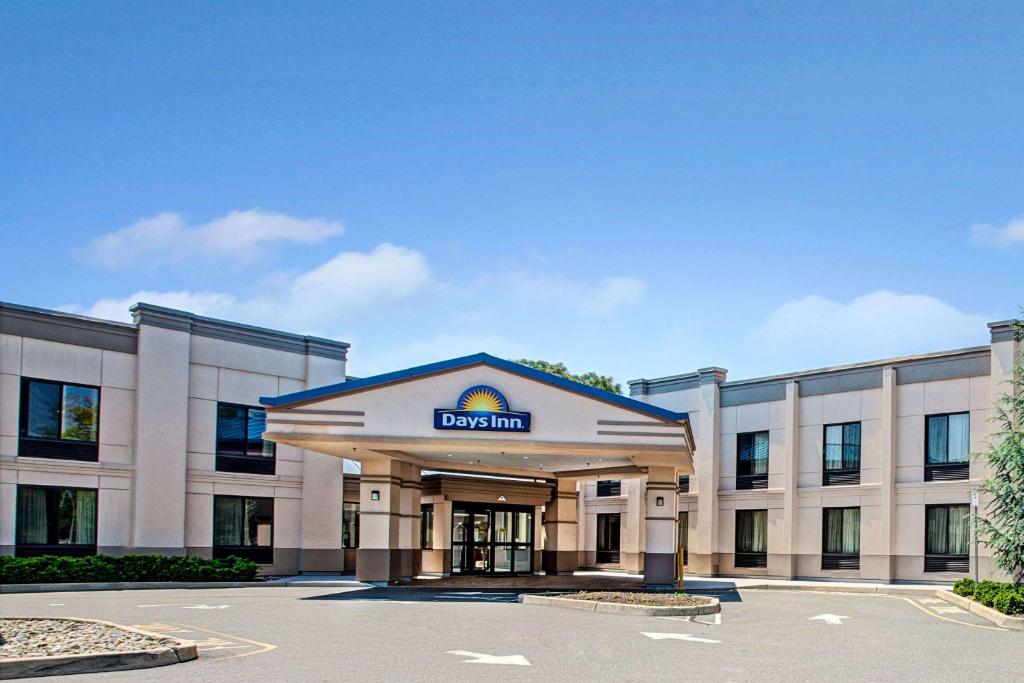 a building with a sign on the front of it at Days Inn by Wyndham Parsippany in Parsippany