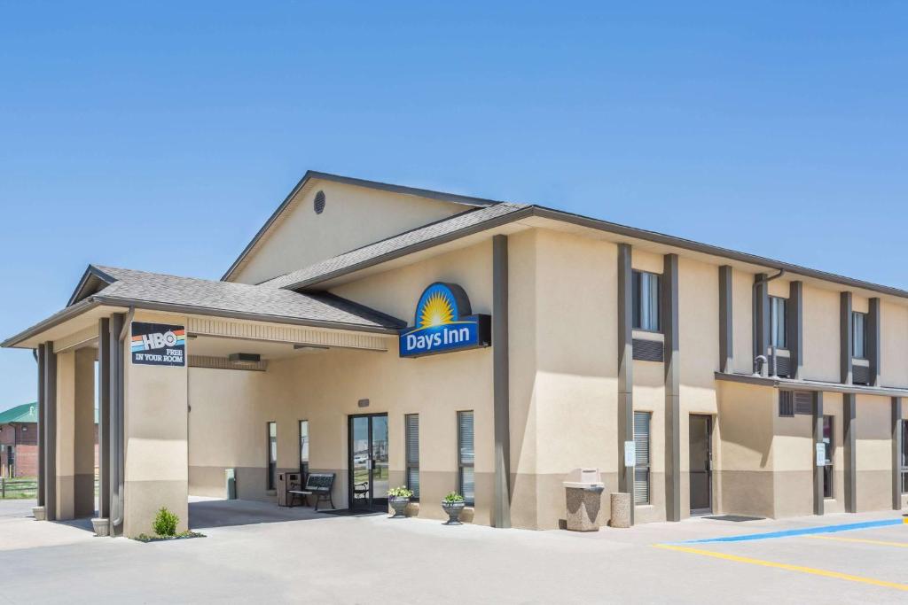 a hotel with a sign on the front of it at Days Inn by Wyndham Colby in Colby