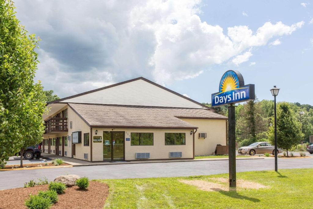 a gas station with a sign in front of it at Days Inn by Wyndham Athens in Athens