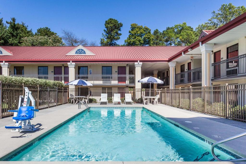 a swimming pool in front of a building at Days Inn by Wyndham Dalton in Dalton